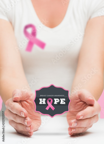 Woman presenting breast cancer awareness message in her hands