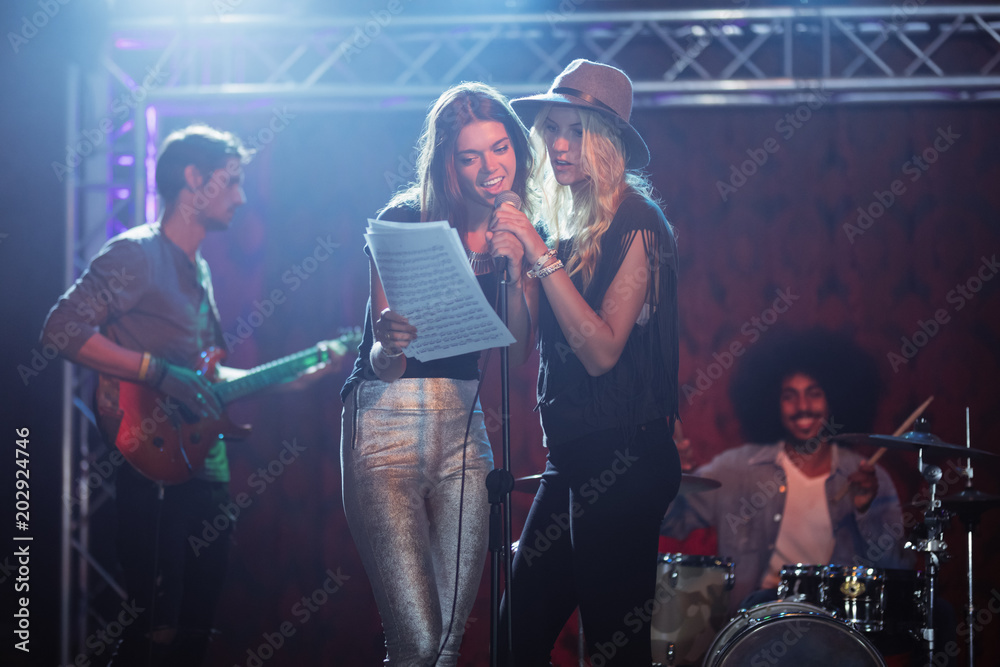 Ταπετσαρία Female singers with male musicians practicing at nightclub