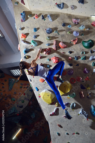 woman climber climbs indoors