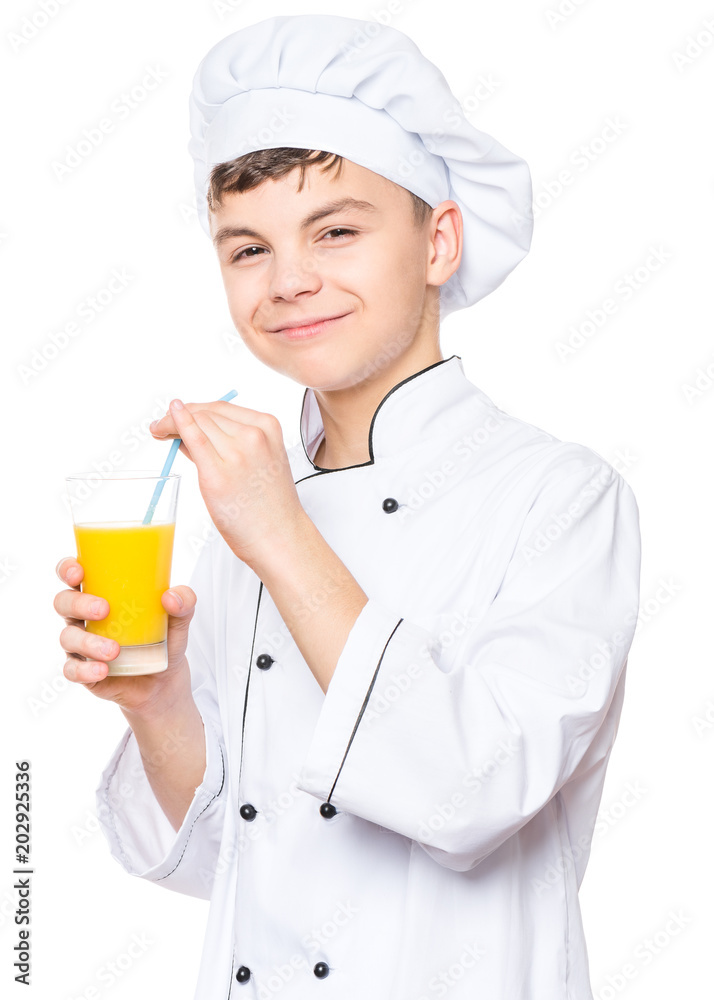 Handsome teen boy wearing chef uniform drinking fresh orange juice. Portrait of a happy cute male child cook with glass, isolated on white background. Food and cooking concept. Handsome teen boy wearing chef uniform drinking fresh orange juice. Portrait of a happy cute male child cook with glass, isolated on white background. Food and cooking concept.