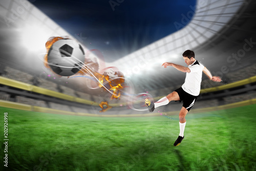 Football player in white kicking against football pitch in large stadium  © vectorfusionart