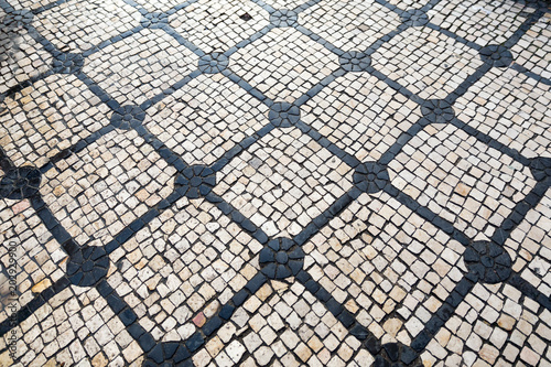 wet black and white pavement in lisbon, portugal