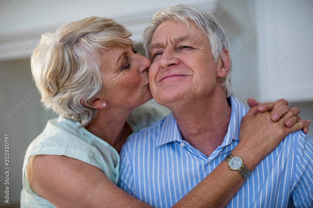 Senior woman kissing her partner