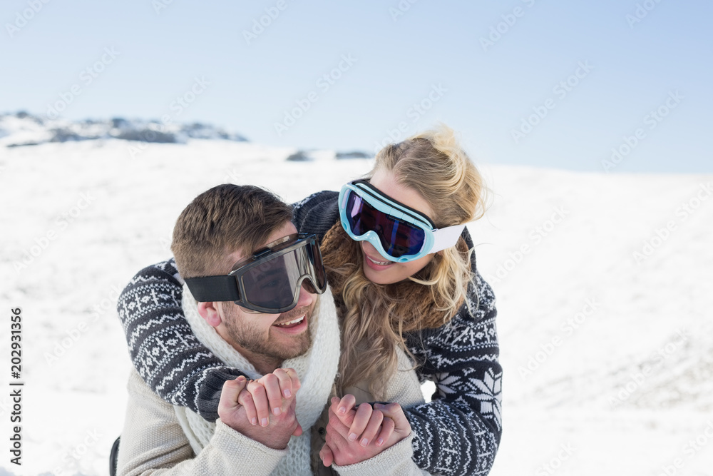 Cheerful couple in ski goggles on snow Cheerful couple in ski goggles on snow
