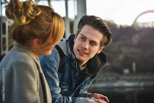 Cheerful couple talking and having fun on the bridge.