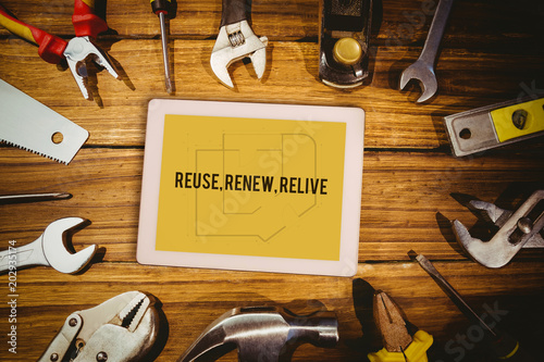 Photos The word reuse, renew, relive and tablet pc against blueprint
