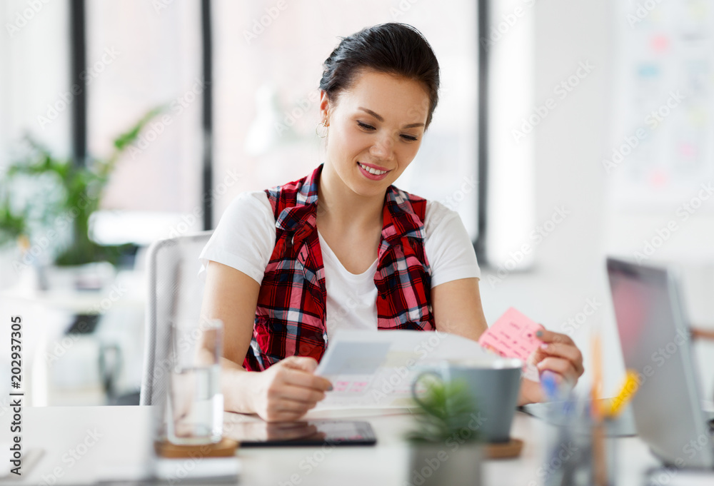 business and people concept - creative woman with papers working at office business and people concept - creative woman with papers working at office