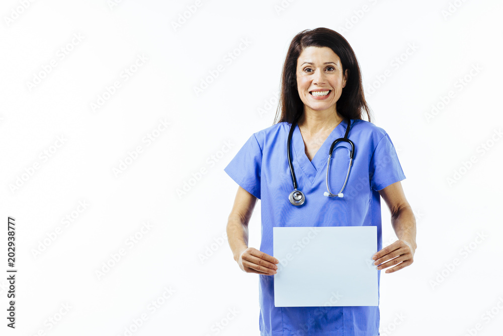 Portrait of a smiling female nurse or doctor in blue uniform holding a blank banner, isolated on white studio background Portrait of a smiling female nurse or doctor in blue uniform holding a blank banner, isolated on white studio background
