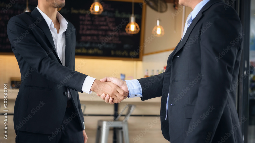 Businessman in black suit handshaking Businessman in black suit handshaking