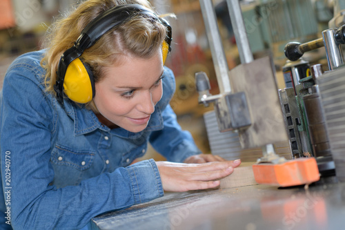 young female carpenter in safety equipment photo