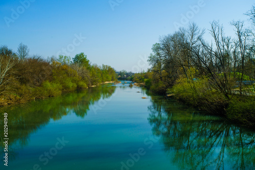 Blue river flowing across green forest