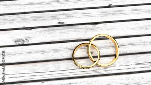 Being forever, eternal bond and feelings, staying together in a relationship, symbolized by two inseparable golden rings on a white wood table, clean, ascetic symbolism photo