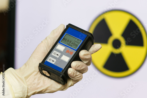 Geiger counter with radioactive materials in the background