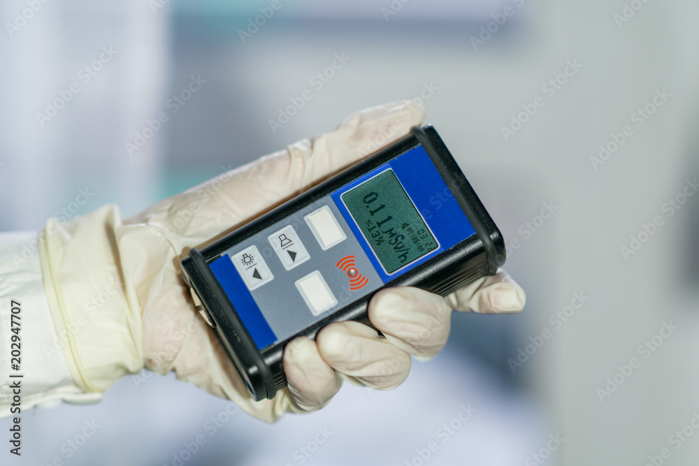 Man checking radiation with geiger counter Man checking radiation with geiger counter