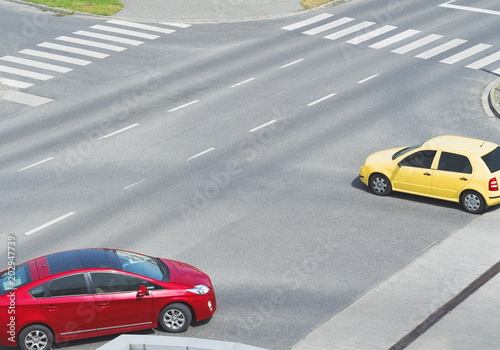 Intersection with Yellow and Red Car