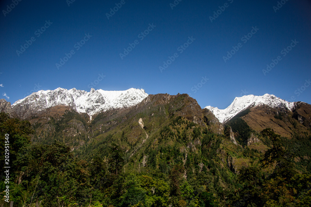 Image of Mansiri Himal range on the Annapurna circuit trek in Nepal. Scenery views of Snow capped peaks and green forest of Himalayas.