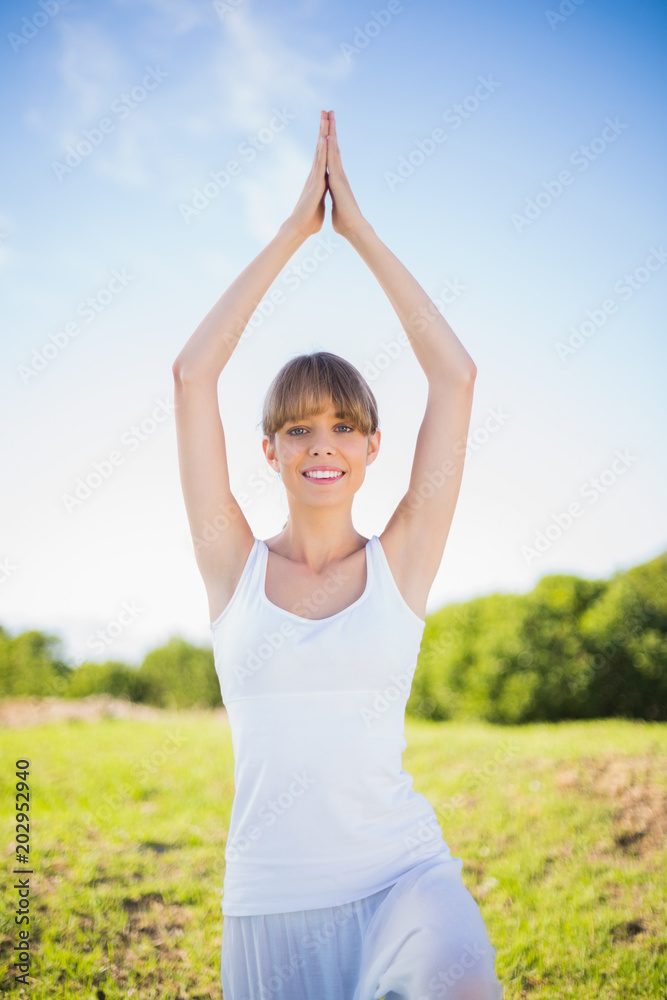 Smiling young woman exercising outside