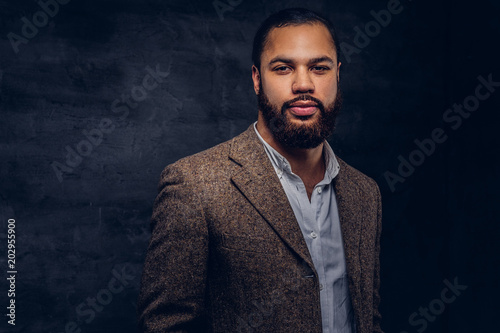 Handsome bearded African-American businessman in a brown classic jacket.
