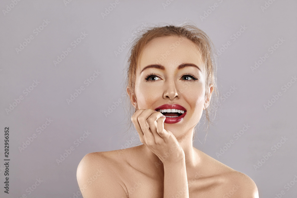 Beautiful Happy Woman Surprised. Perfect Smile. Fashion Red Lips Make-up. Expressive emotional face Beautiful Happy Woman Surprised. Perfect Smile. Fashion Red Lips Make-up. Expressive emotional face
