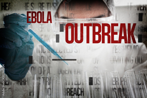 Protected female scientist dropping a blue liquid in a test tube against ebola words photo