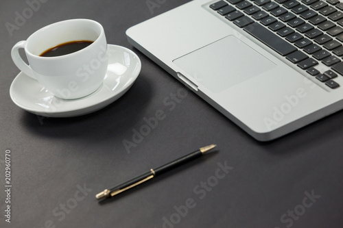 Cup of coffee, laptop and pen