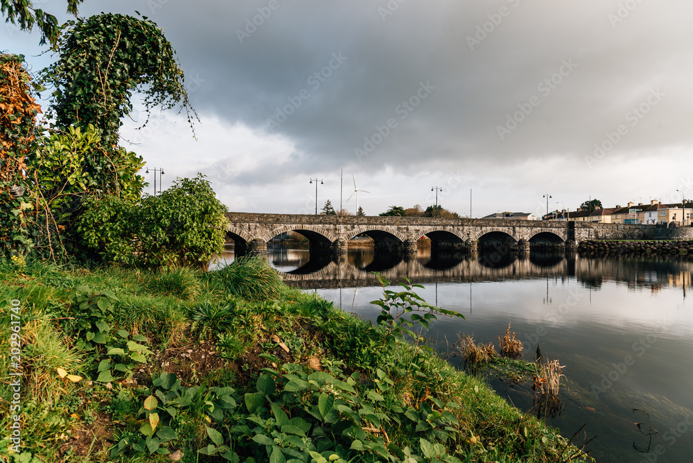 Fototapeta premium Beautiful bridge and reflections on river at morning