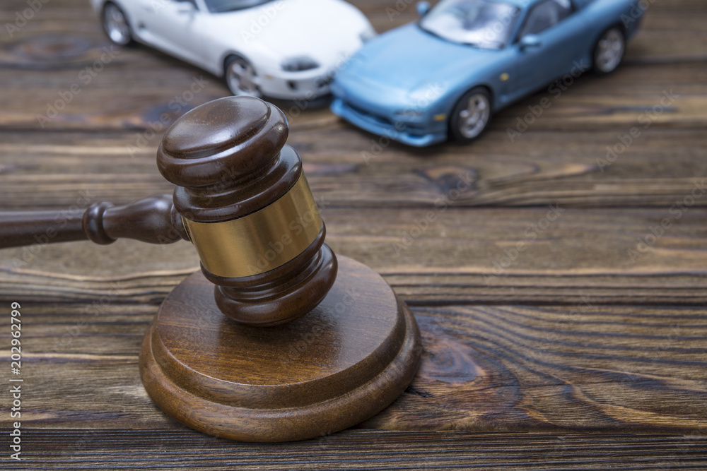 hammer of the judge. two collided cars. The concept of liability for traffic violations. Accident, insurance, compensation, crash. hammer of the judge. two collided cars. The concept of liability for traffic violations. Accident, insurance, compensation, crash.