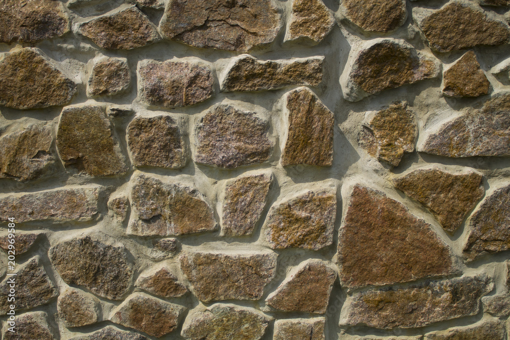 Texture of an old stone wall close-up Texture of an old stone wall close-up