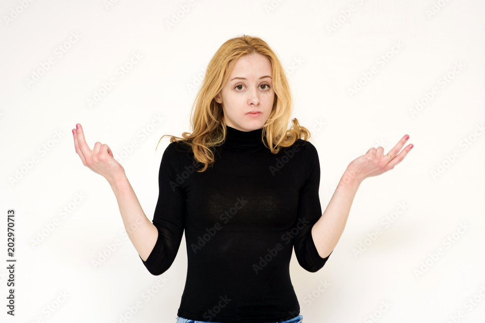 Portrait of a beautiful blonde girl on a white background showing misunderstanding.