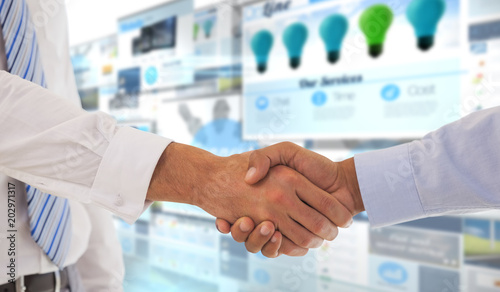 Close-up shot of a handshake in office against screen collage showing business advertisement