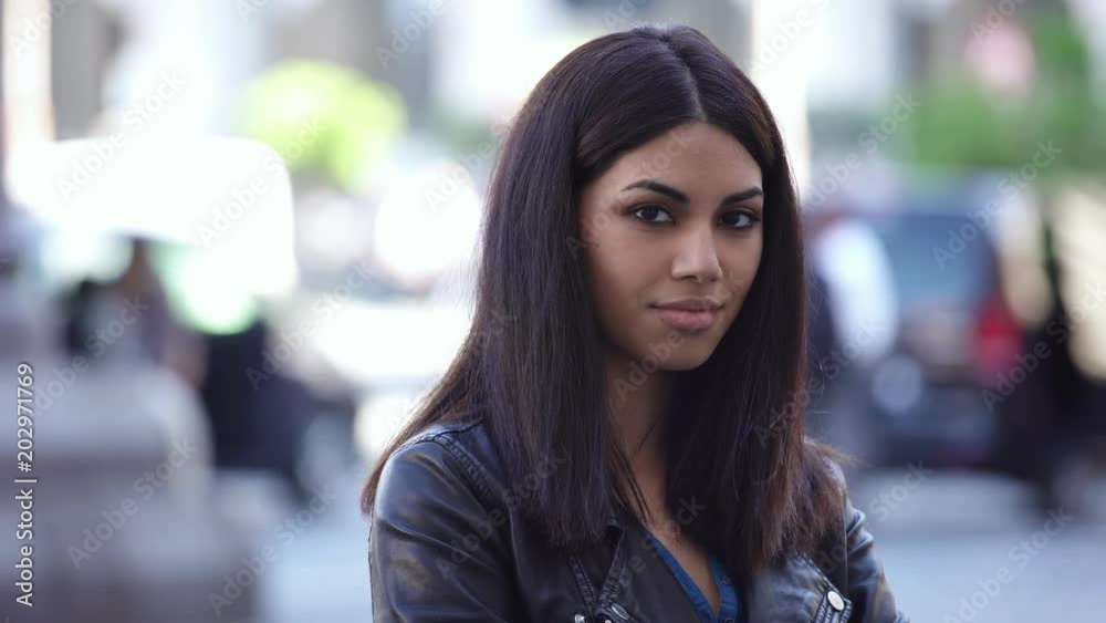 Beautiful asian woman in the street smiling at camera Beautiful asian woman in the street smiling at camera