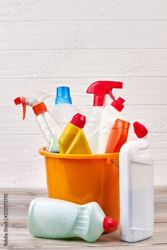 Set of cleaning and sanitation products. Variety of cleaning detergents in colorful bucket. Household chores and cleaning concept.