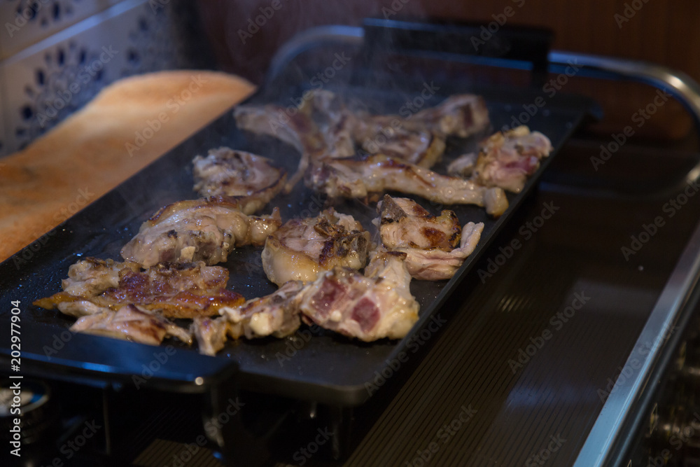 Grilled lamb chops on the grill in the kitchen. Grilled lamb chops on the grill in the kitchen.