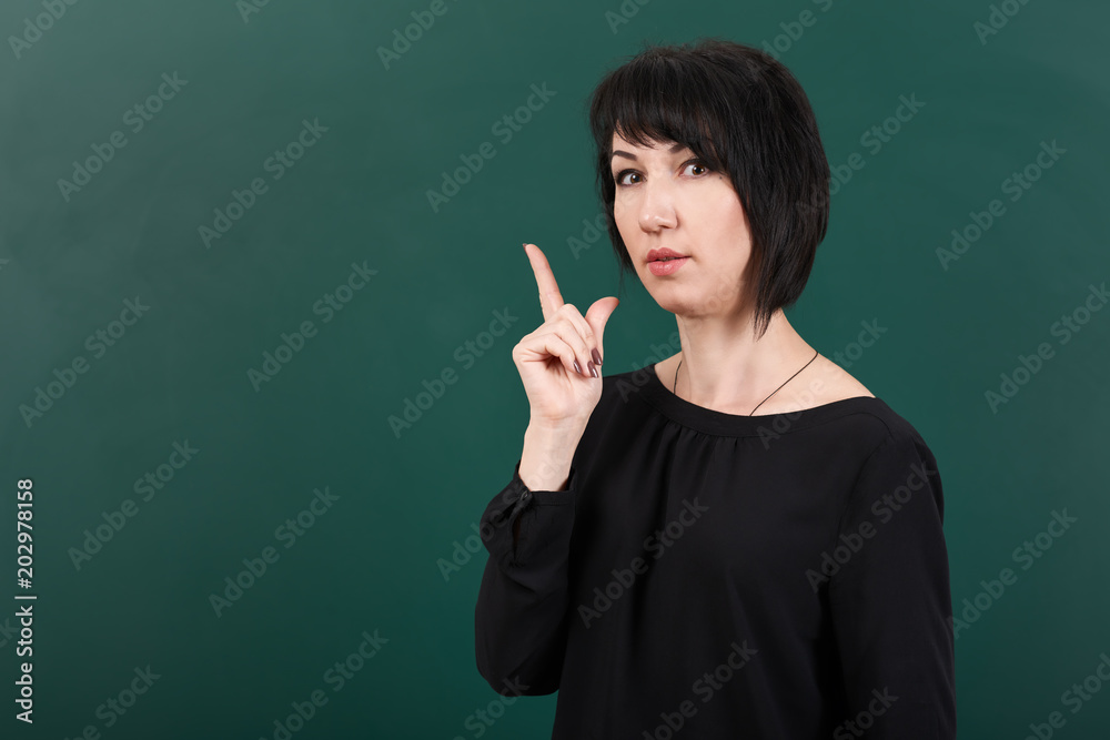 teacher having idea and posing by chalk Board, learning concept, green background, Studio shot teacher having idea and posing by chalk Board, learning concept, green background, Studio shot