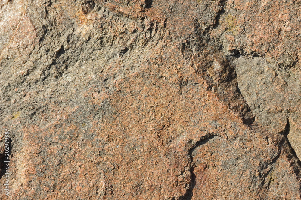 Natural stone granite texture, granite pattern. Stone background of mottled granite igneous rock used for kitchen worktops etc. Surface of the marble with brown tint. Minimalism