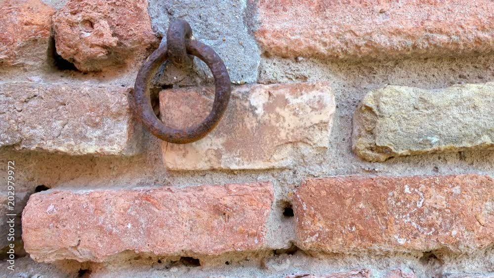 rusty iron ring on brick wall background rusty iron ring on brick wall background