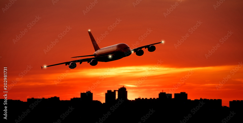 Huge commercial airplane flying above city skyline Huge commercial airplane flying above city skyline