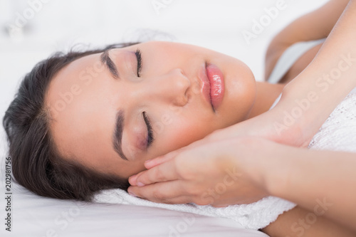 Closeup of a pretty woman sleeping with eyes closed in a bed