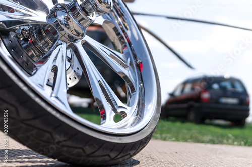 Motorcycle close-up. Detail of a beautiful powerful chrome motorcycle wheels. The concept of freedom and travel. custom works. Metallic shiny new internal combustion engine