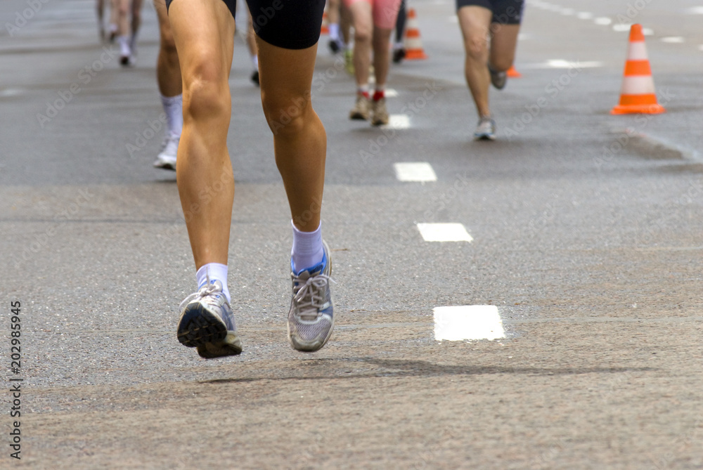 Female runner legs outdoors, leading in marathon