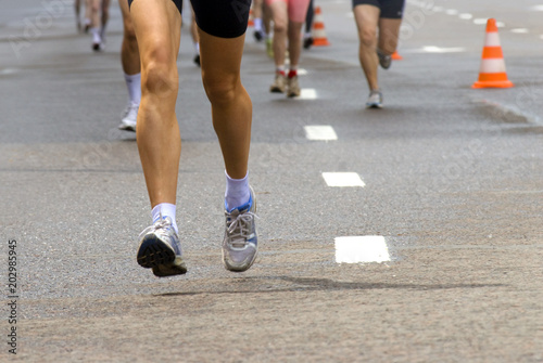 Female runner legs outdoors, leading in marathon