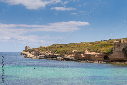 Beautiful azure turquoise Mediterranean sea and white chalk limestone cliffs of St Thomas Bay, walking, trekking, hiking along the Munxar Path, Marsaskala, Malta