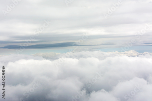 Fototapeta Naklejka Na Ścianę i Meble -  Clouds through an airplane window
