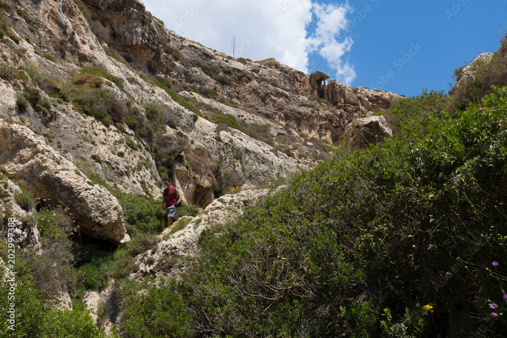 Φωτογραφία Exploring Wied Babu, at Wied iz-Zurrieq, green rocky valley, leading down to the