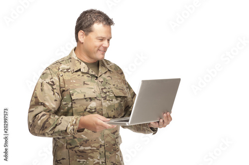 U.S. Army Soldier, Sergeant. Isolated with computer laptop.