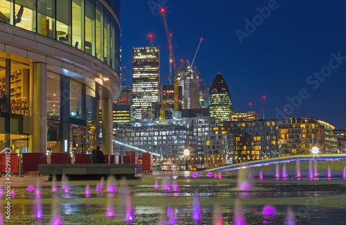 LONDON, GREAT BRITAIN - SEPTEMBER 19, 2017: The view from More London riverside across the fountian to skyscrapers in the center at dusk. photo