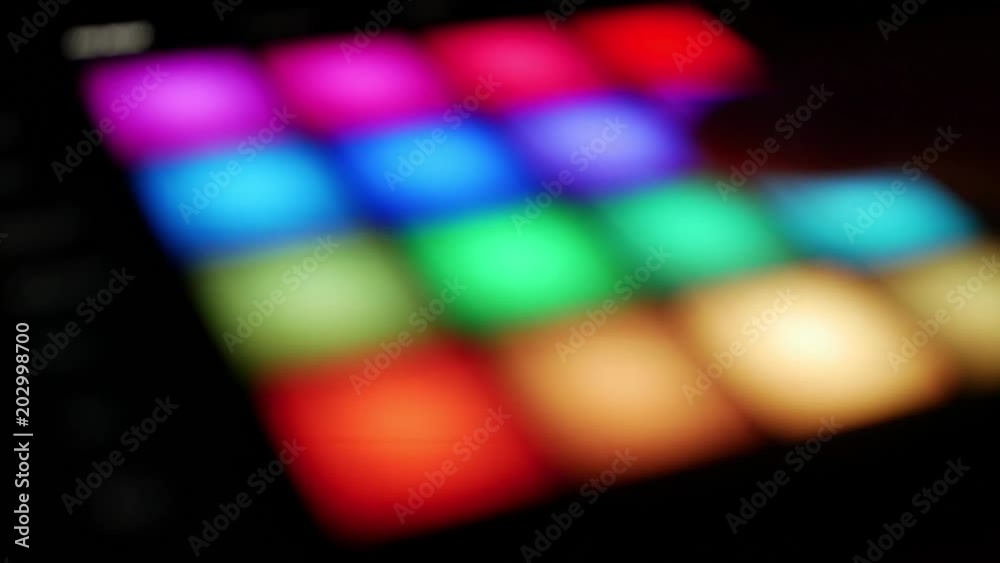 Using furutistic techology with colorful touch pads, professional studio environment, creating music - out of focus bokeh effect