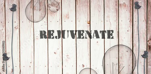 Tablou pe pânză The word rejuvenate  against wooden background with plugs