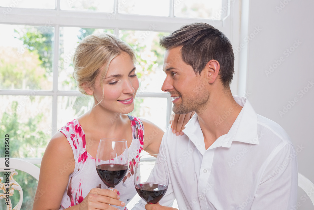 Happy loving young couple with wine glasses Happy loving young couple with wine glasses