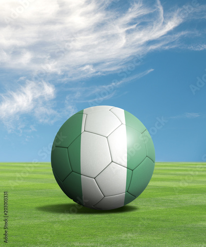 Soccer ball with Nigeria flags in a green field  